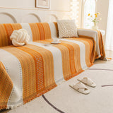Orange Arrow Metro Stripe sofa throw seen from the side on a corner sofa, view 4