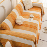 Orange Arrow Metro Stripe sofa throw shown across the seat and backrest of a two-seater, view 4