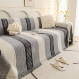 Pearl Grey Metro Stripe sofa throw seen from the side on a corner sofa, view 2