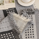 Pearl Grey Metro Stripe sofa throw photographed at an angle beside a floor lamp, view 2