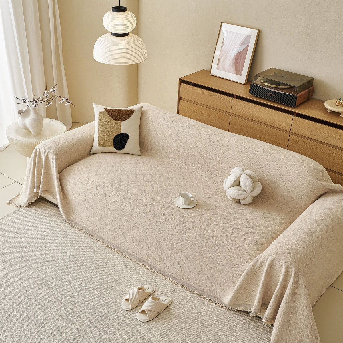 Ivory Cream Relief Weave sofa throw draped over a three-seater sofa in a bright living room