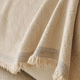 Ivory Cream Relief Weave sofa throw covering the arm and seat of a sectional