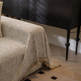 Boucle-Style Sand Spotted sofa throw seen from the side on a corner sofa
