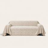Boucle-Style Sand Spotted sofa throw on a plain studio background
