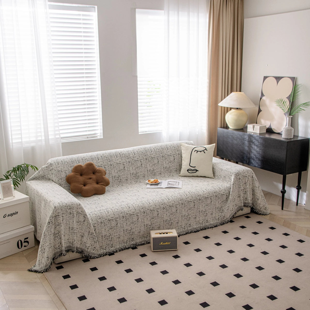 Pearl Grey Spotted sofa throw draped over a three-seater sofa in a bright living room, view 2