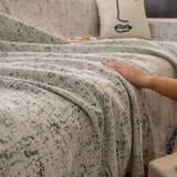 Pearl Grey Spotted sofa throw covering the arm and seat of a sectional, view 2