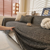 Charcoal Tweed Knit sofa throw shown across the seat and backrest of a two-seater