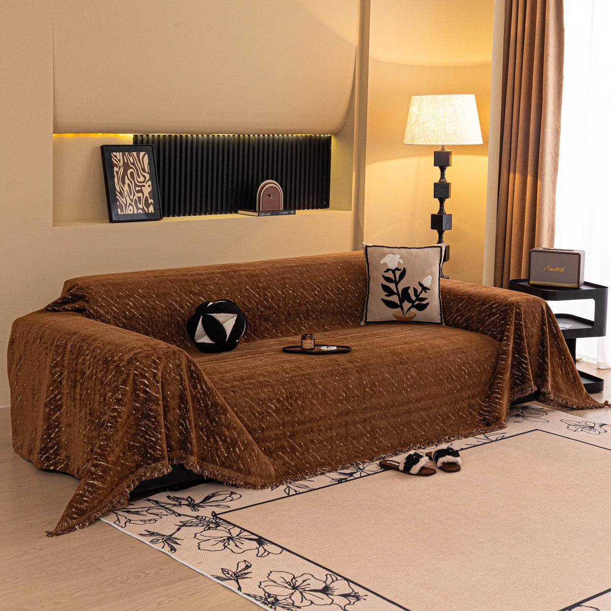 Auburn Brown Velvet Embossed sofa throw draped over a three-seater sofa in a bright living room
