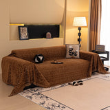 Auburn Brown Velvet Embossed sofa throw draped over a three-seater sofa in a bright living room