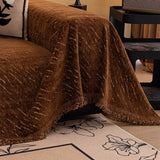 Auburn Brown Velvet Embossed sofa throw photographed at an angle beside a floor lamp