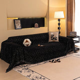 Ink Black Velvet Embossed sofa throw draped over a three-seater sofa in a bright living room, view 3