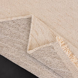 Ivory Cream Velvet Embossed sofa throw photographed at an angle beside a floor lamp, view 2