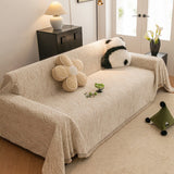 Boucle-Style Sand Wave Quilted sofa throw draped over a three-seater sofa in a bright living room, view 2