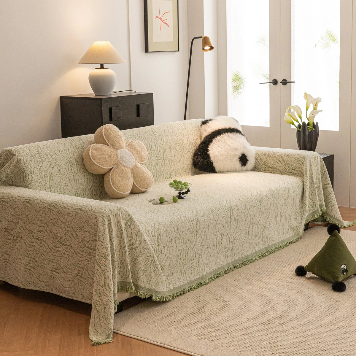 Lime Mist Wave Quilted sofa throw draped over a three-seater sofa in a bright living room