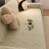 Lime Mist Wave Quilted sofa throw seen from the side on a corner sofa