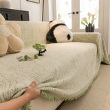 Lime Mist Wave Quilted sofa throw shown across the seat and backrest of a two-seater