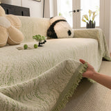 Lime Mist Wave Quilted sofa throw styled with cushions on a low-back sofa