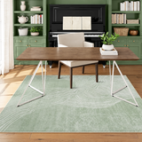 Fern green abstract terrain rug in a home office, walnut desk set in front of a green built-in wall unit and piano