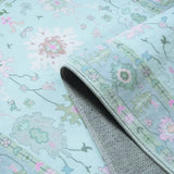 Covaba boho oushak floral rug in teal haze, styled in a room setting