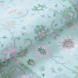Covaba boho oushak floral rug in teal haze, styled in a room setting, view 2