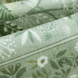 Covaba modern botanical floral rug in sage mist, styled in a room setting