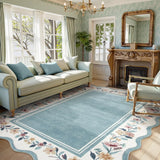 Covaba vintage floral scalloped area rug in dusty blue, styled in a room setting, view 2