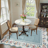 Covaba vintage floral scalloped area rug in dusty blue, styled in a room setting, view 4
