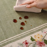 Covaba vintage floral scalloped area rug in willow sage, styled in a room setting, view 10