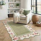 Covaba vintage floral scalloped area rug in willow sage, styled in a room setting, view 11