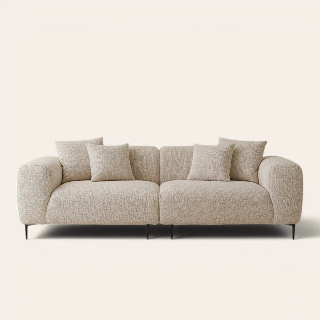 Almond cream chenille stretch cover fitted on a plush three-seat sofa, front view on ivory backdrop