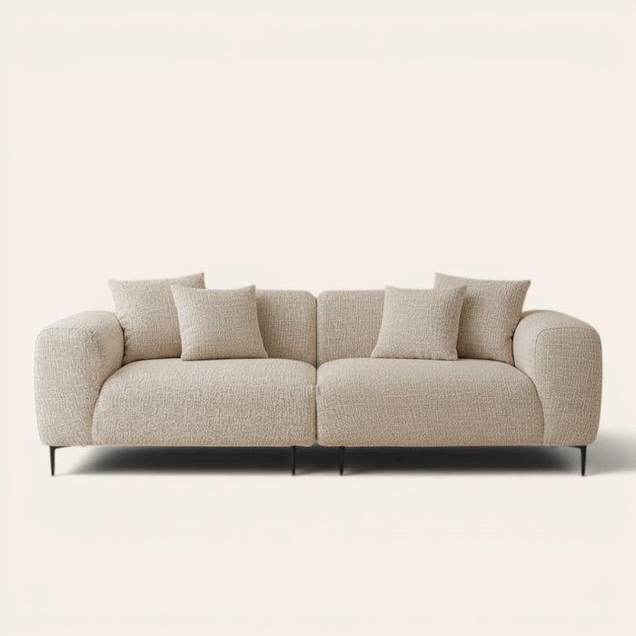 Almond cream chenille stretch cover fitted on a plush three-seat sofa, front view on ivory backdrop