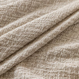 Almond cream chenille fabric draped in close-up, highlighting its textured weave