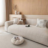 Side view of the almond cream chenille sofa cover showing the soft woven texture across seat and armrest
