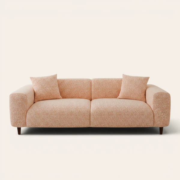 Peach clay chenille stretch cover fitted on a plush three-seat sofa, front view on ivory backdrop