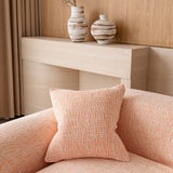 Peach clay chenille sofa cover with a matching cushion on the seat, beside a wood console