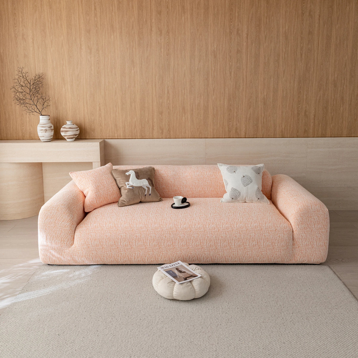 Peach clay chenille sofa cover on a three-seat sofa in a warm wood-paneled living room, front view