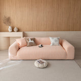 Peach clay chenille sofa cover on a three-seat sofa in a warm wood-paneled living room, front view