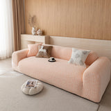 Side view of the peach clay chenille sofa cover showing the soft woven texture across seat and armrest