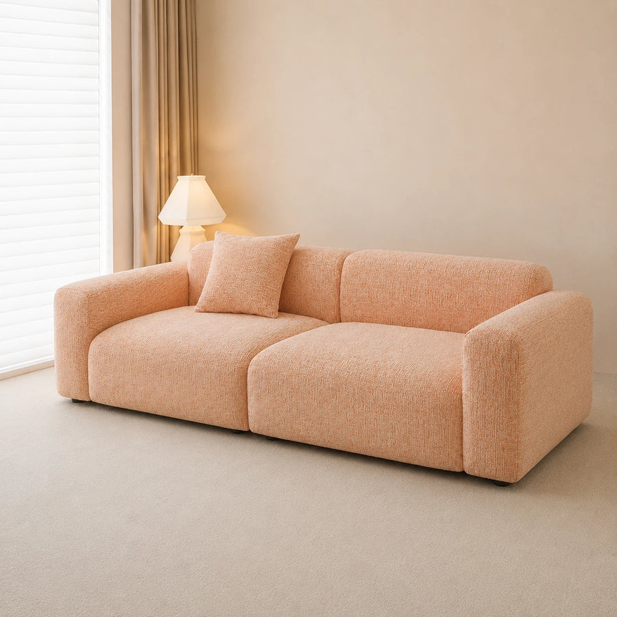 Peach clay chenille sofa cover, side angle in a bright room with a lamp and matching cushion