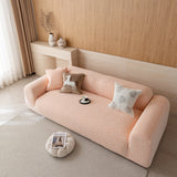 Wide angled view of the peach clay chenille sofa cover on a rounded sofa with a floor pouf