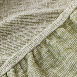 Close-up of the gathered elastic edge on the sage veil chenille sofa cover