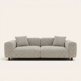 Stone mist chenille stretch cover fitted on a plush three-seat sofa, front view on ivory backdrop