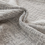 Macro of stone mist chenille fabric in soft folds showing the woven texture