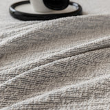 Stone mist chenille seat in close-up with a mug on a tray, showing the textured weave