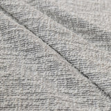 Stone mist chenille fabric draped in close-up, highlighting its textured weave