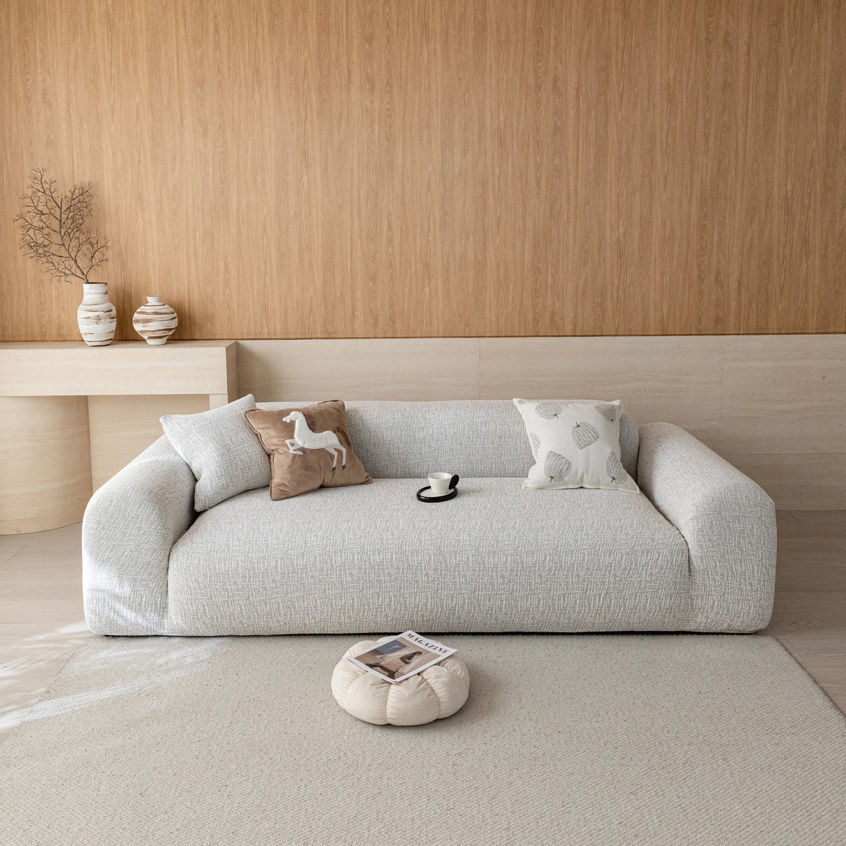 Stone mist chenille sofa cover on a three-seat sofa in a warm wood-paneled living room, front view