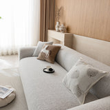 Close angled view of the stone mist chenille seat with a leaf print cushion