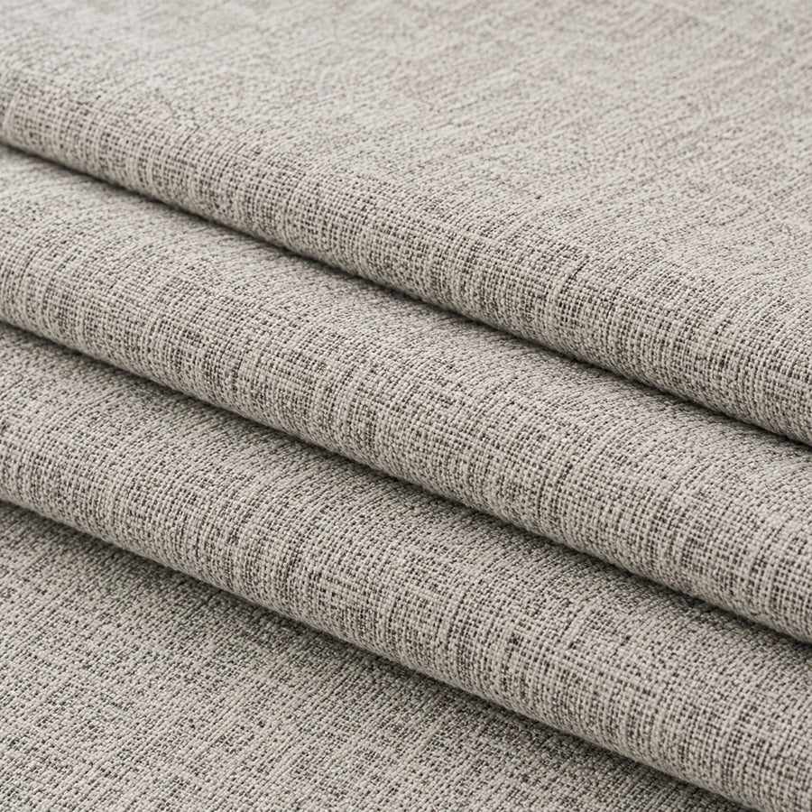 Folded stack of stone mist chenille fabric in close-up, highlighting the woven weave