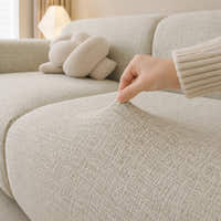 Hand pinching the willow haze chenille seat fabric, showing its stretch and woven texture