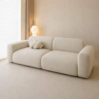 Willow haze chenille sofa cover on a plush sofa, side angle with knot cushion by the window